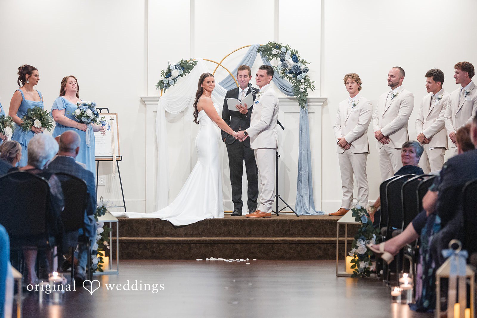 Jaclyn + Mason Bride and groom standing before a decorated wedding altar.