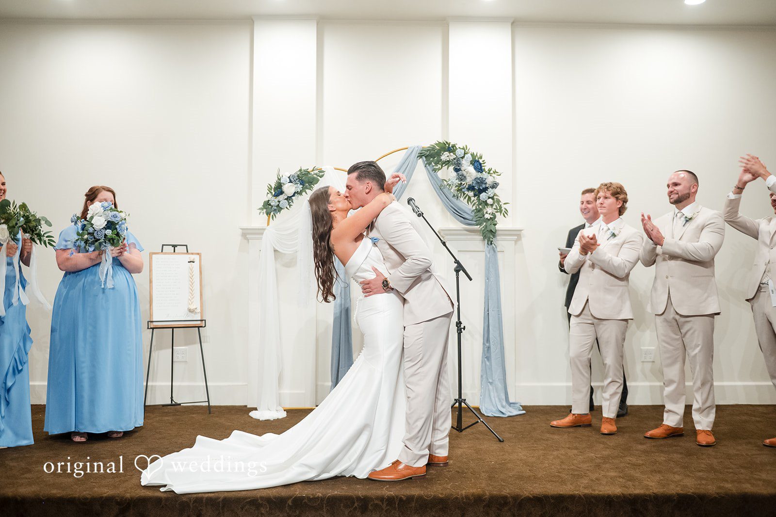 Jaclyn + Mason Bride and groom sharing a kiss during their ceremony.