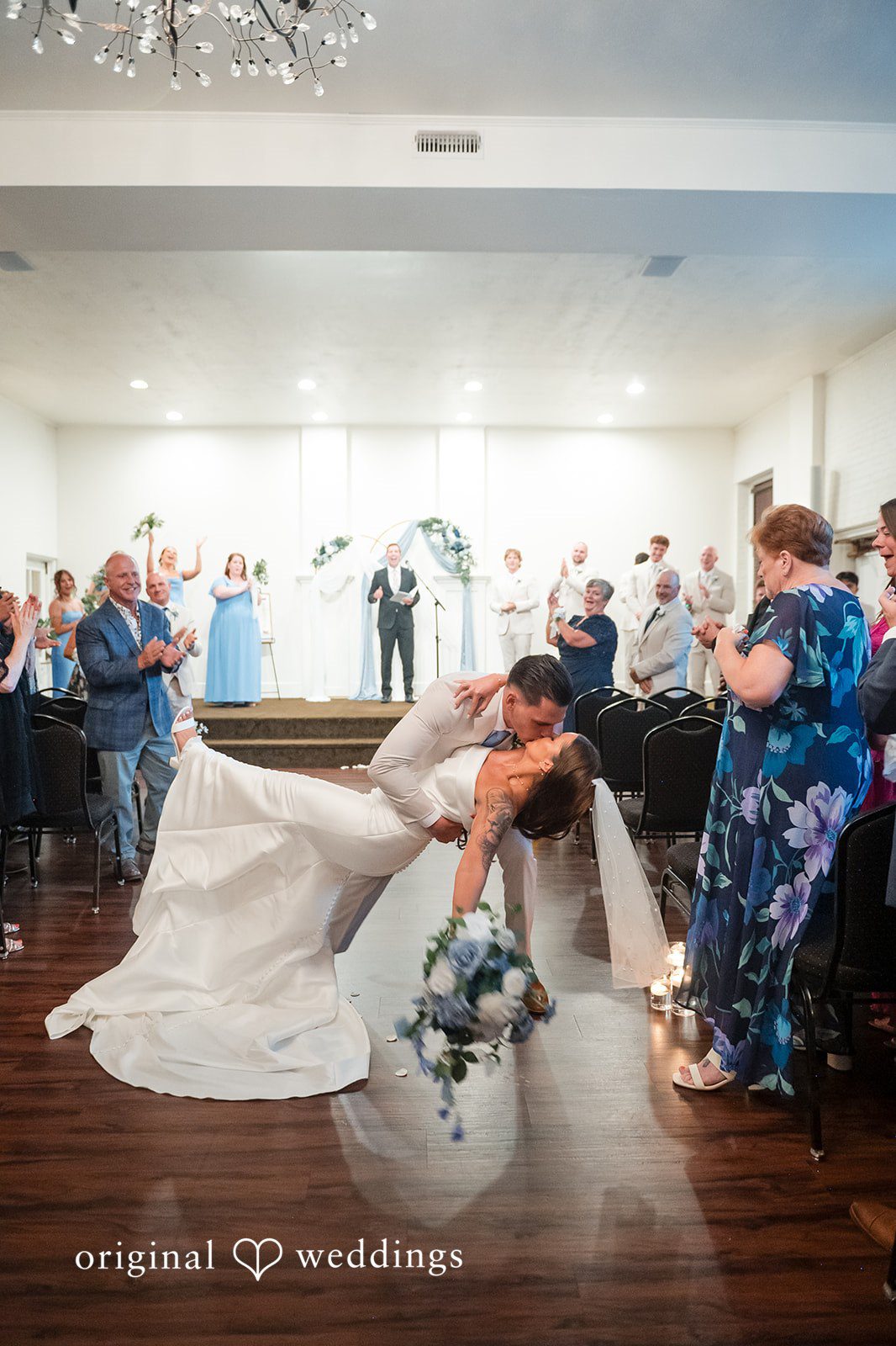 Jaclyn + Mason Bride walking down the aisle with guests watching.