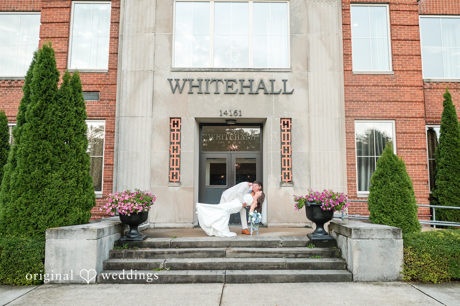 Jaclyn + Mason Bride and groom posing on the steps of a building named Whitehall.