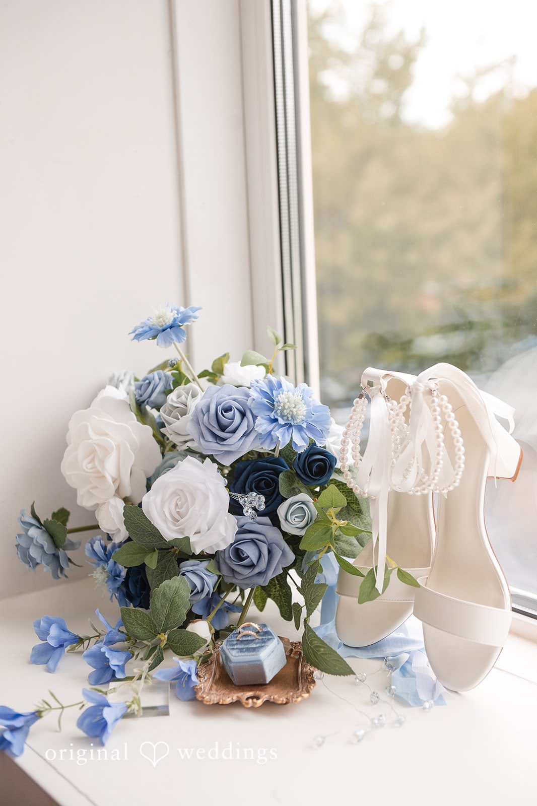 Jaclyn + Mason Blue and white floral arrangement next to a small sign.