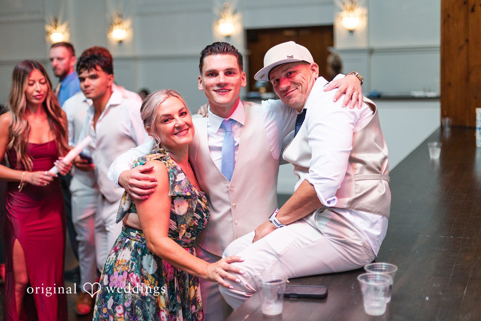 Jaclyn + Mason Groom and wedding guests cheering and dancing together in a crowd.