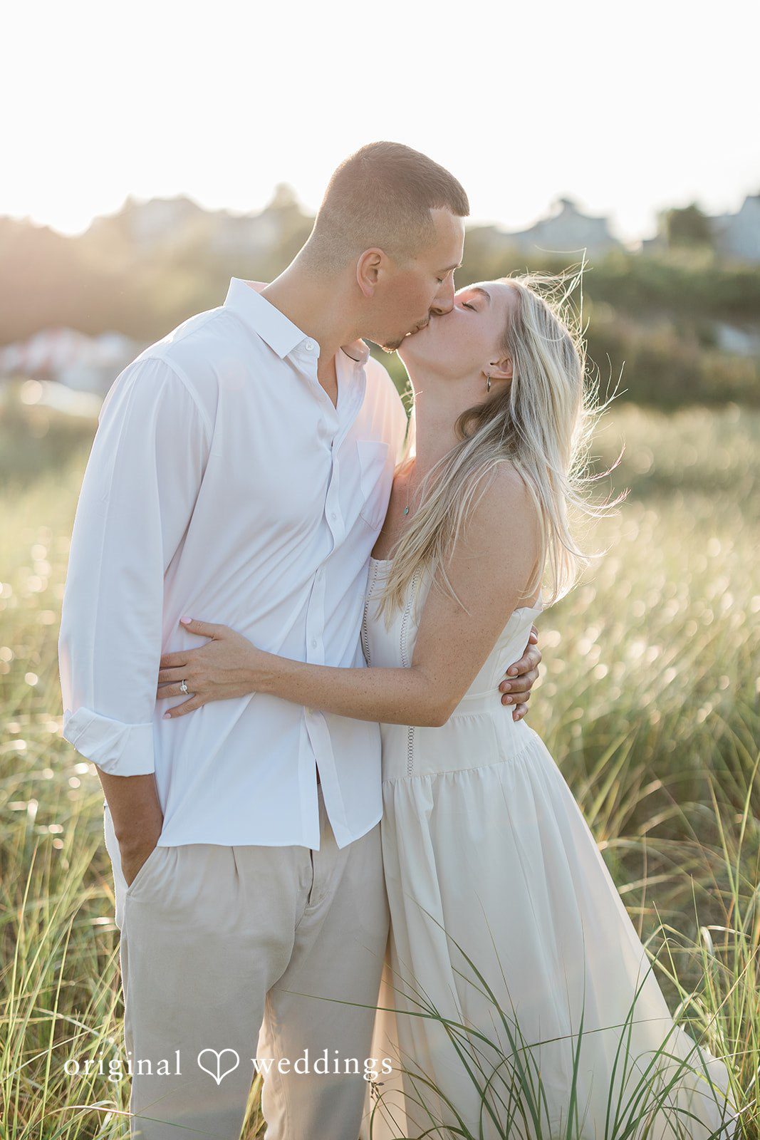 A couple sharing an intimate embrace and kissing.