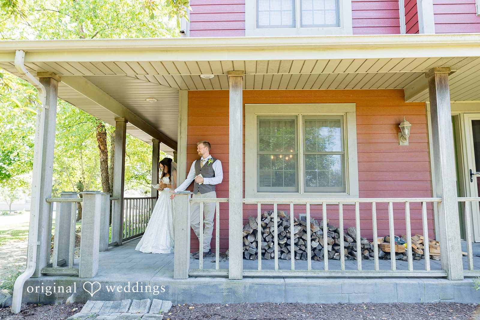 Melayna + Harley A bride stands on the porch of a rustic house.