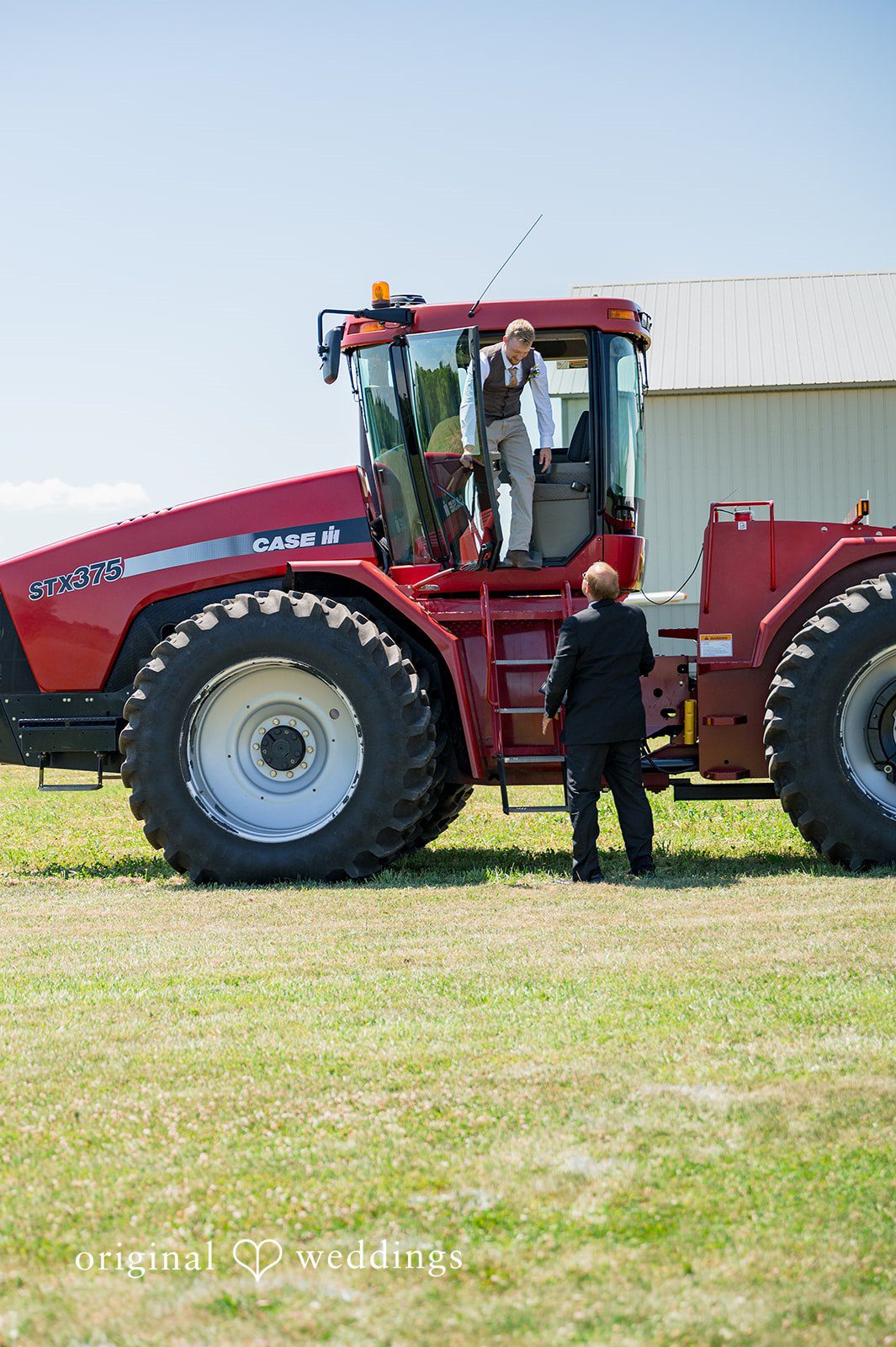 Melayna + Harley A red tractor is parked in an open field.