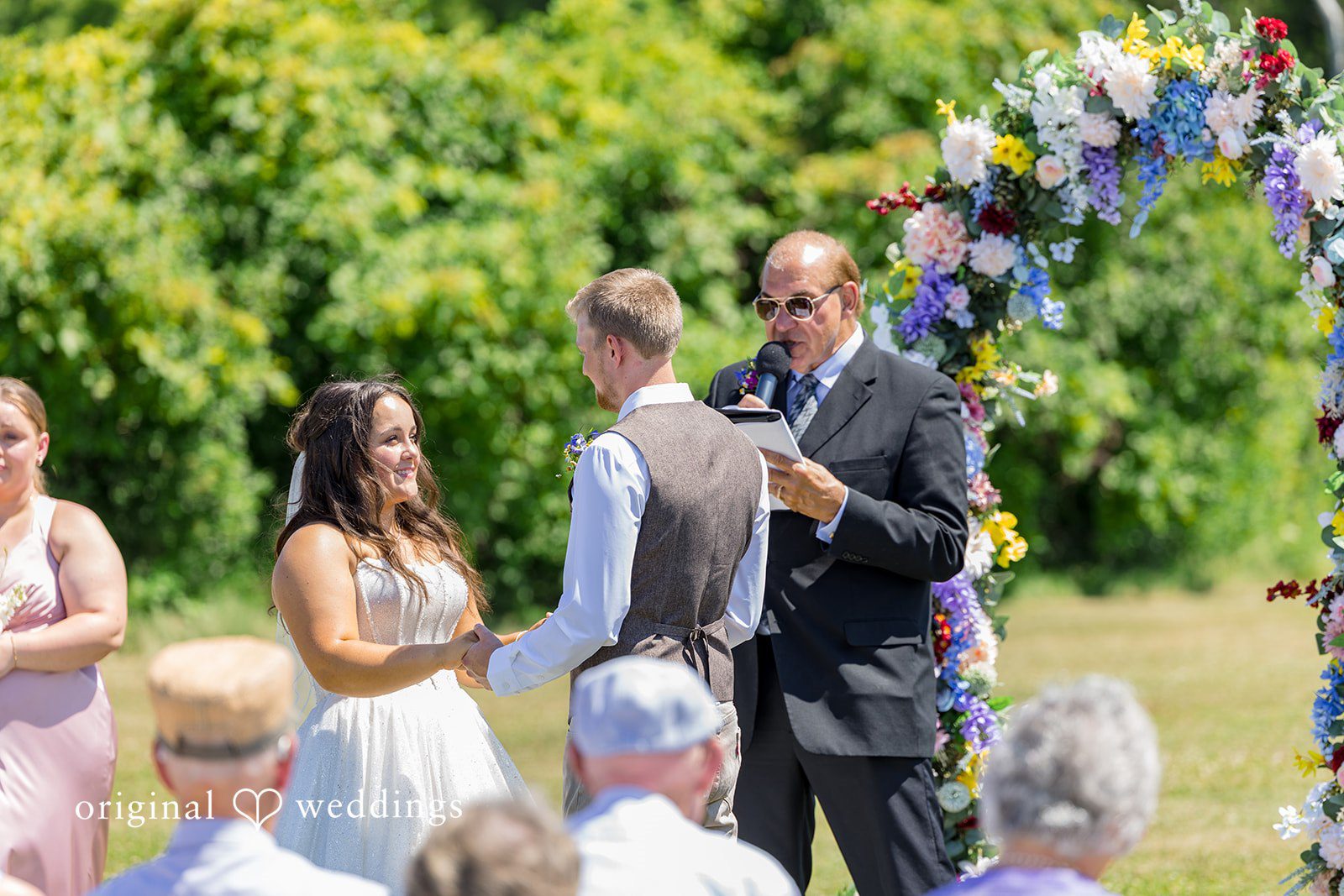 Melayna + Harley Guests watch a wedding ceremony from their seats.