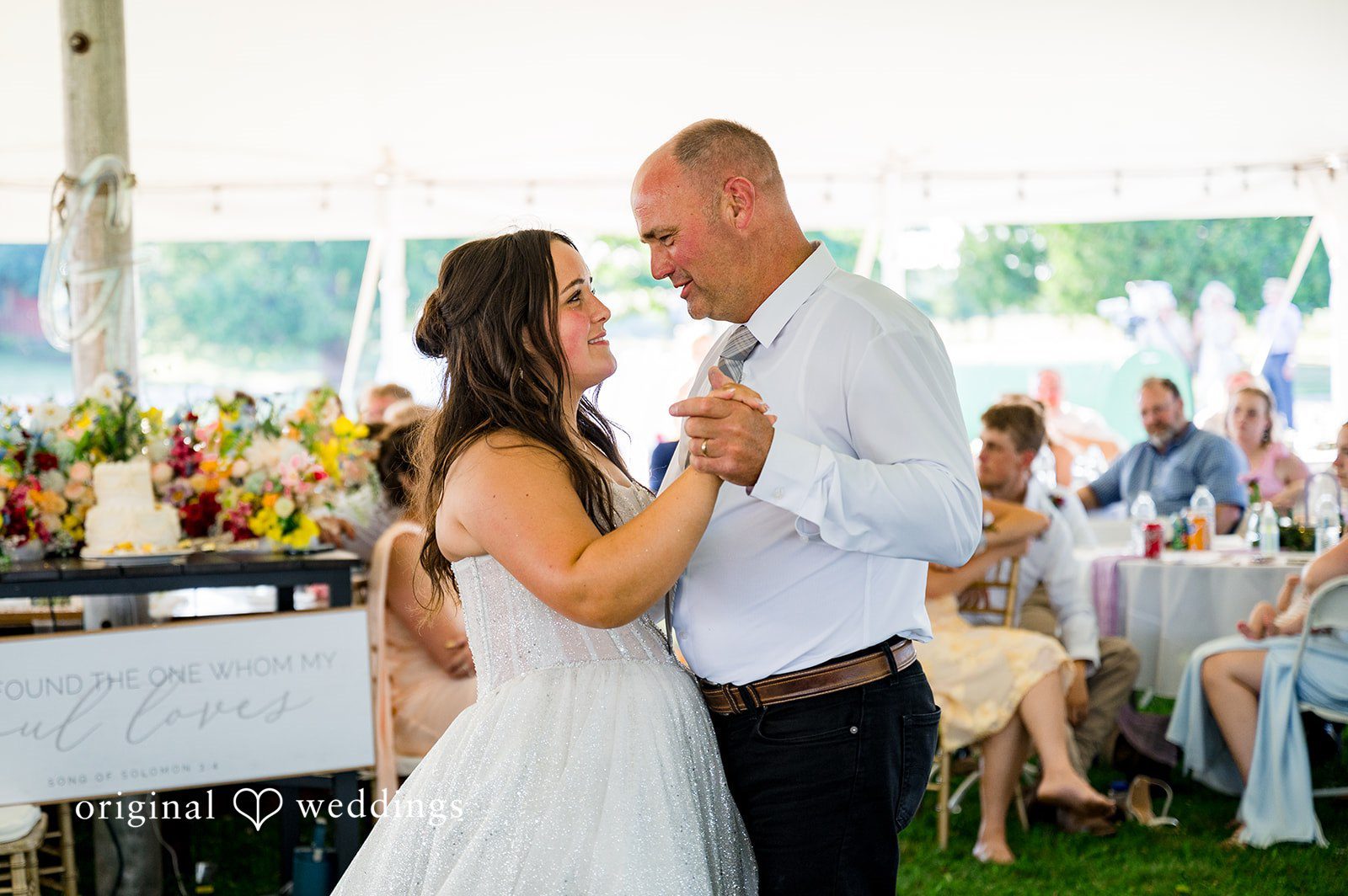 Melayna + Harley A bride and man look at each other lovingly at their reception.