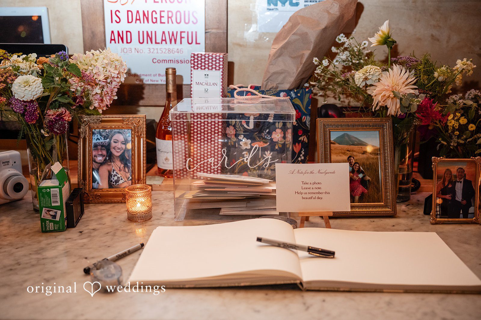 Claudio + Claire Guestbook table with photos and a sign