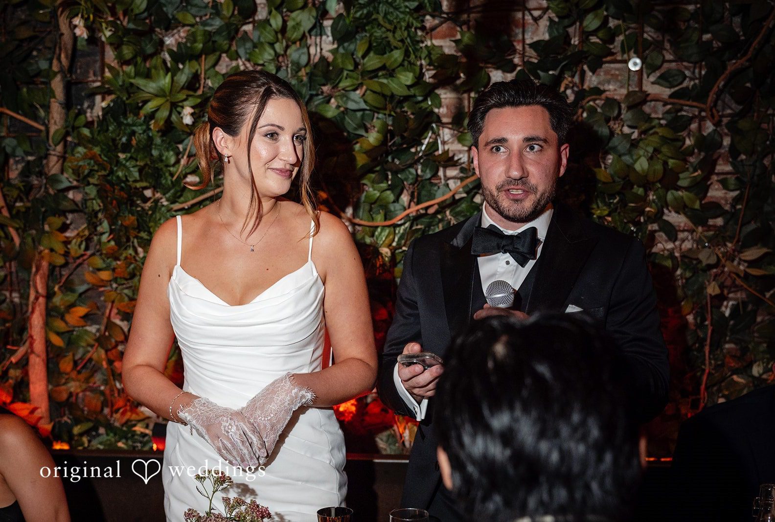 Claudio and Claire smiling together during toasts, captured by New York wedding photographers from Original Weddings at Ainslie