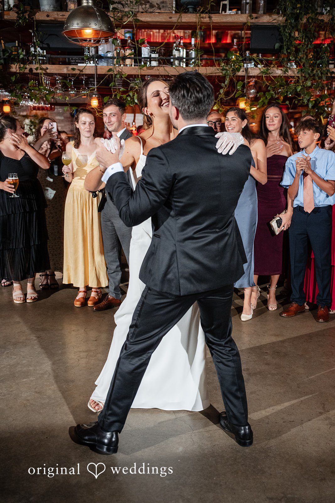 Claudio + Claire Bride and groom dancing surrounded by guests
