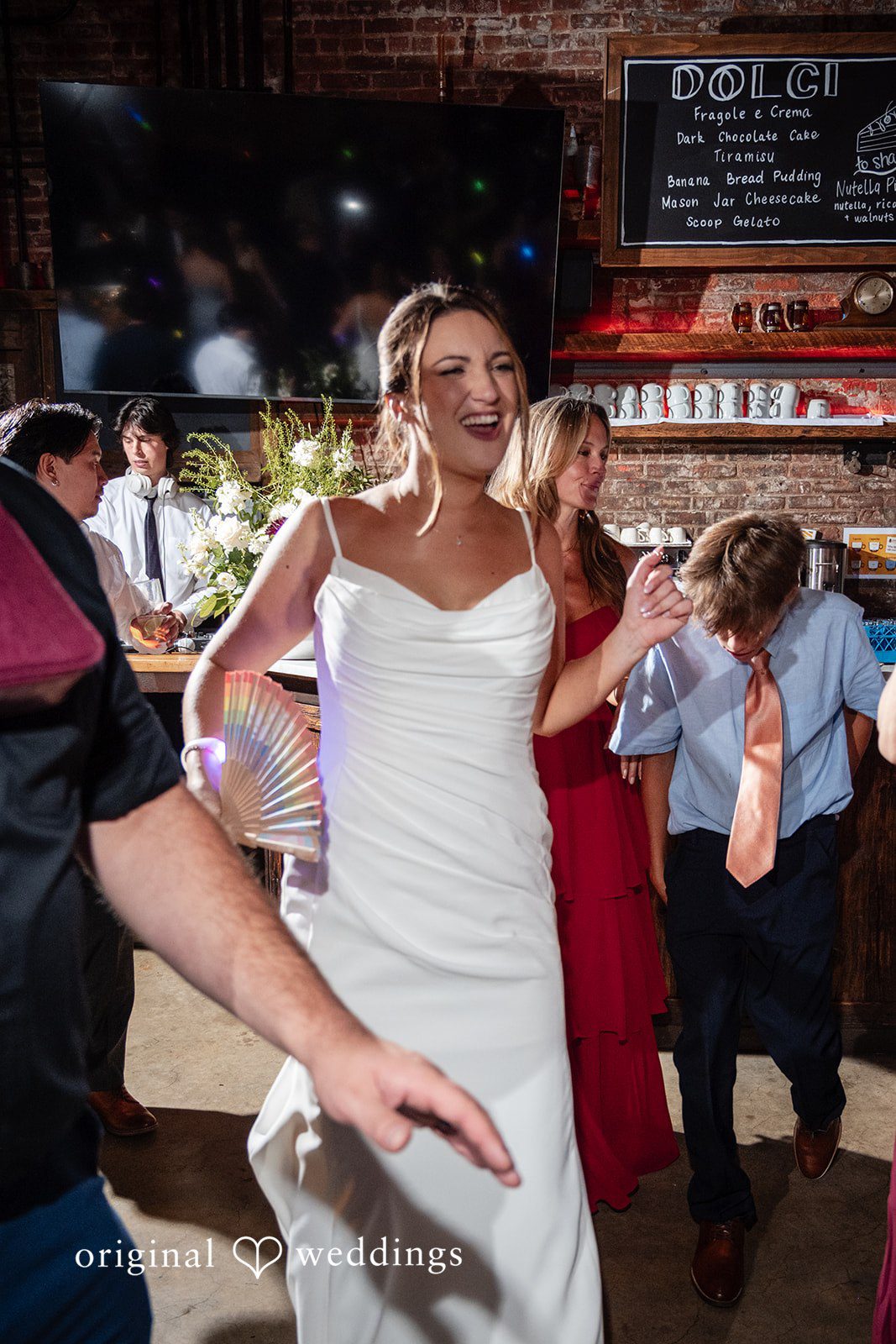Claudio + Claire Bride dancing with friends on the dance floor