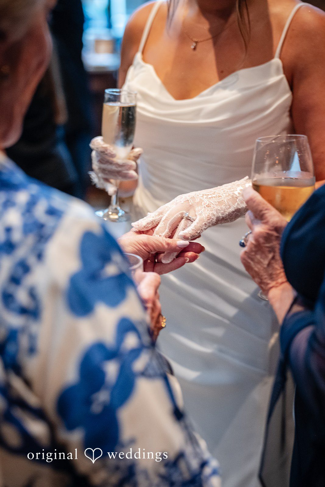 Claudio + Claire Bride holding hands with a guest