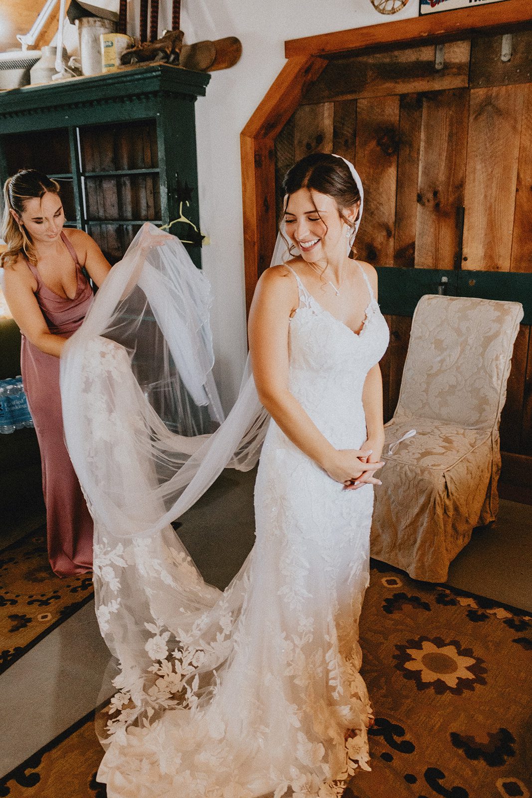 Bride putting on her veil in the barn Bride putting on her veil in the barn