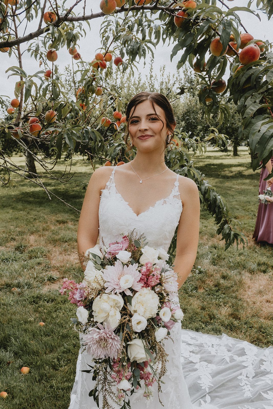 Bride holding her bouquet in the orchard Bride holding her bouquet in the orchard