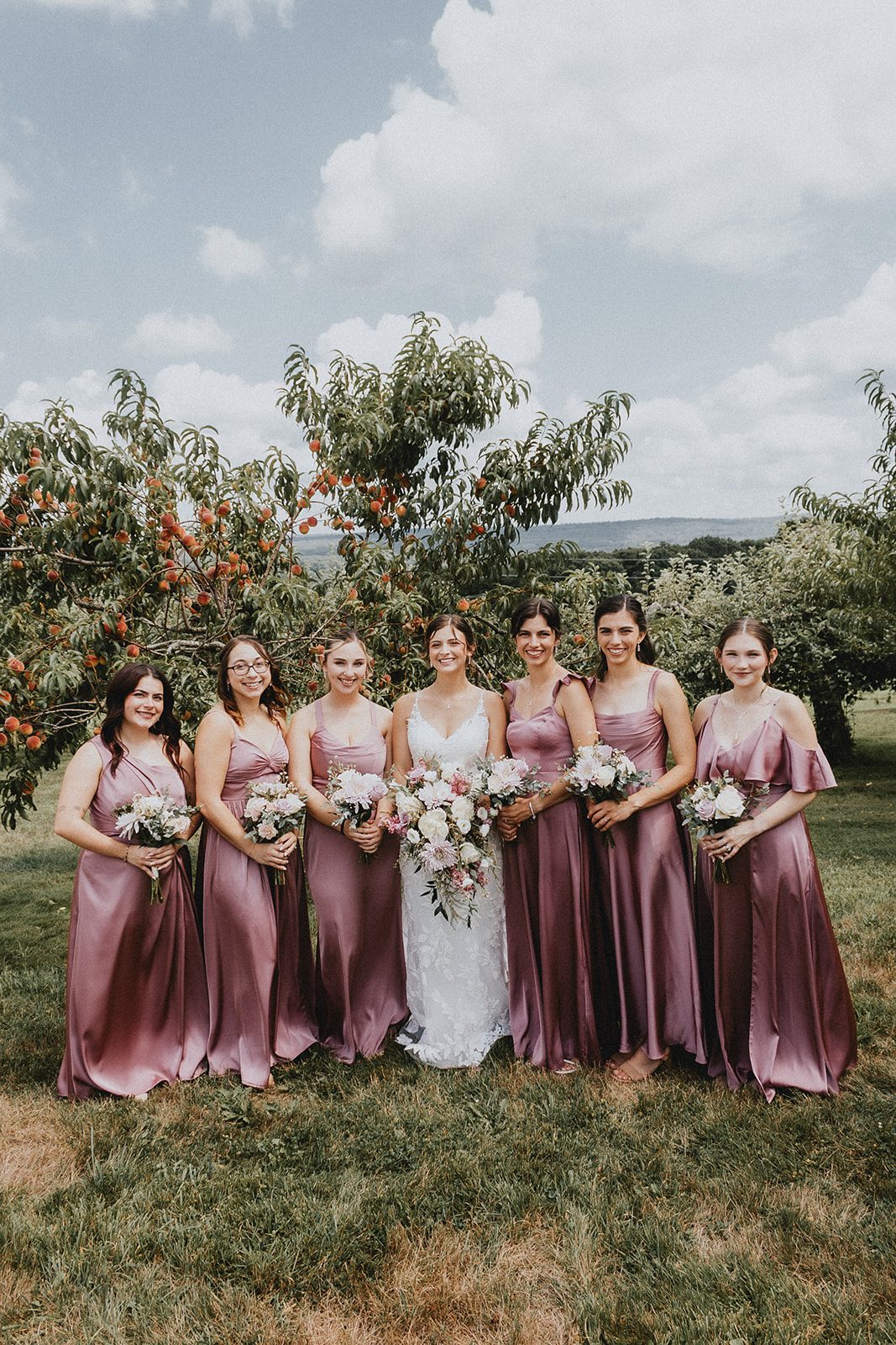 Bride with her bridesmaids in the orchard at Allen Hill Farm Bride with her bridesmaids in the orchard at Allen Hill Farm
