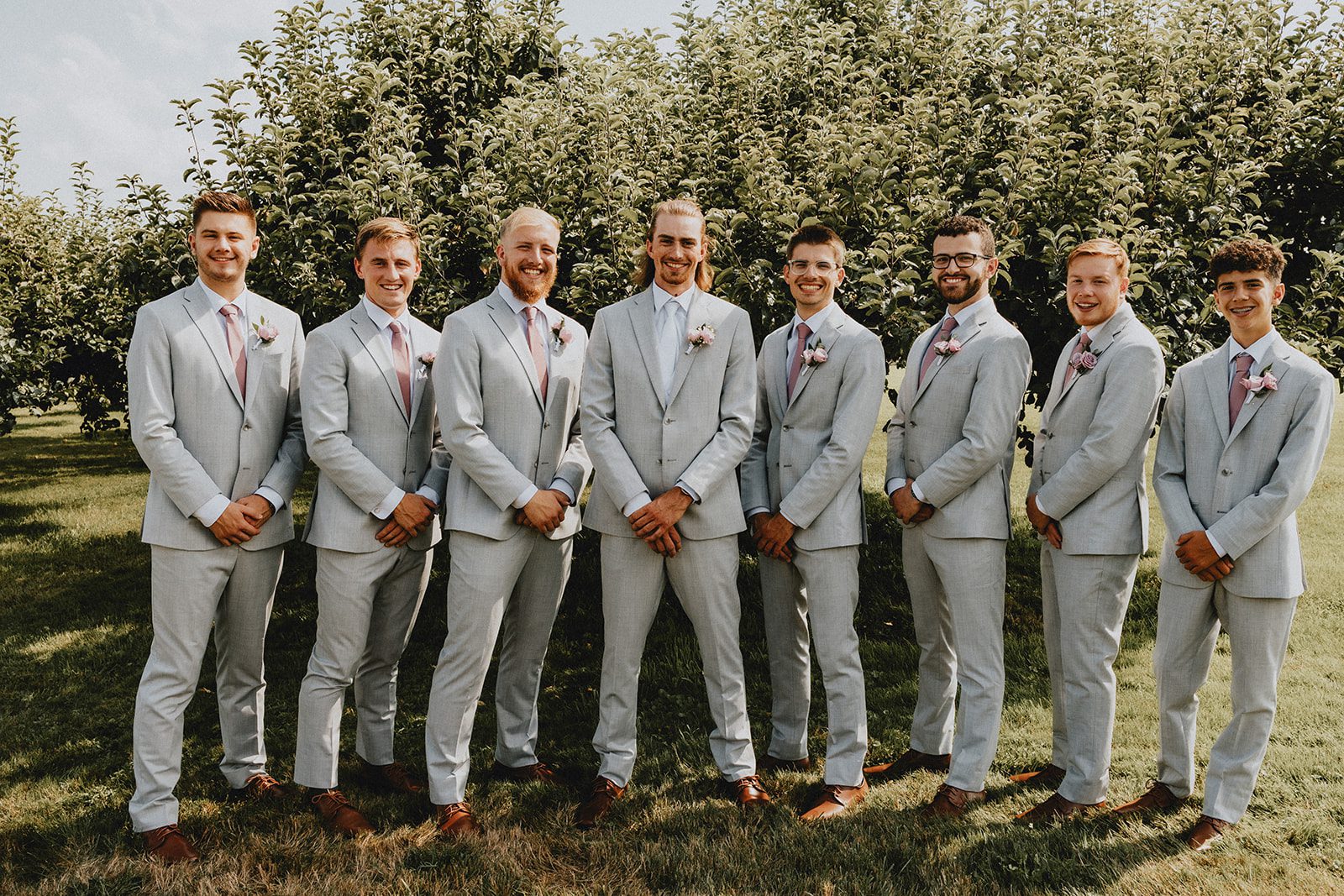 Groom with his groomsmen in the orchard at Allen Hill Farm Groom with his groomsmen in the orchard at Allen Hill Farm