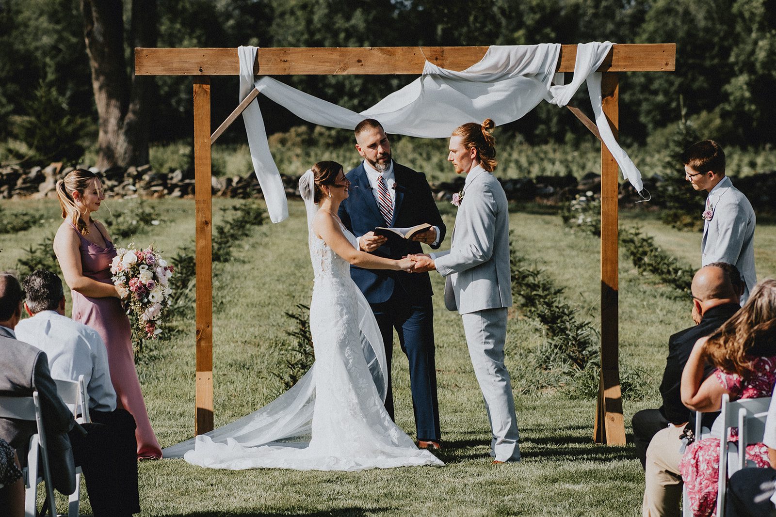 Ceremony under the draped arbor Ceremony under the draped arbor