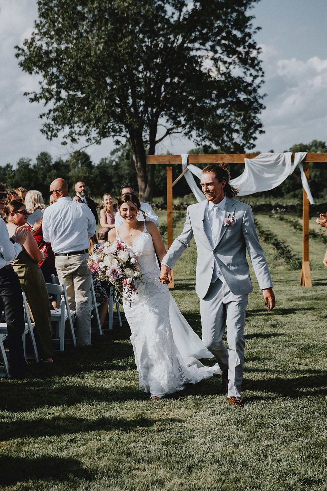 Newlyweds walking back down the aisle at Allen Hill Farm Newlyweds walking back down the aisle at Allen Hill Farm