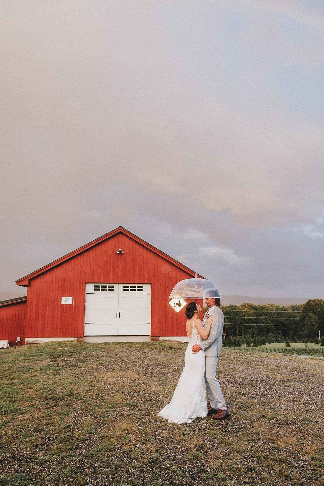 Bride standing by the barn at golden hour Bride standing by the barn at golden hour