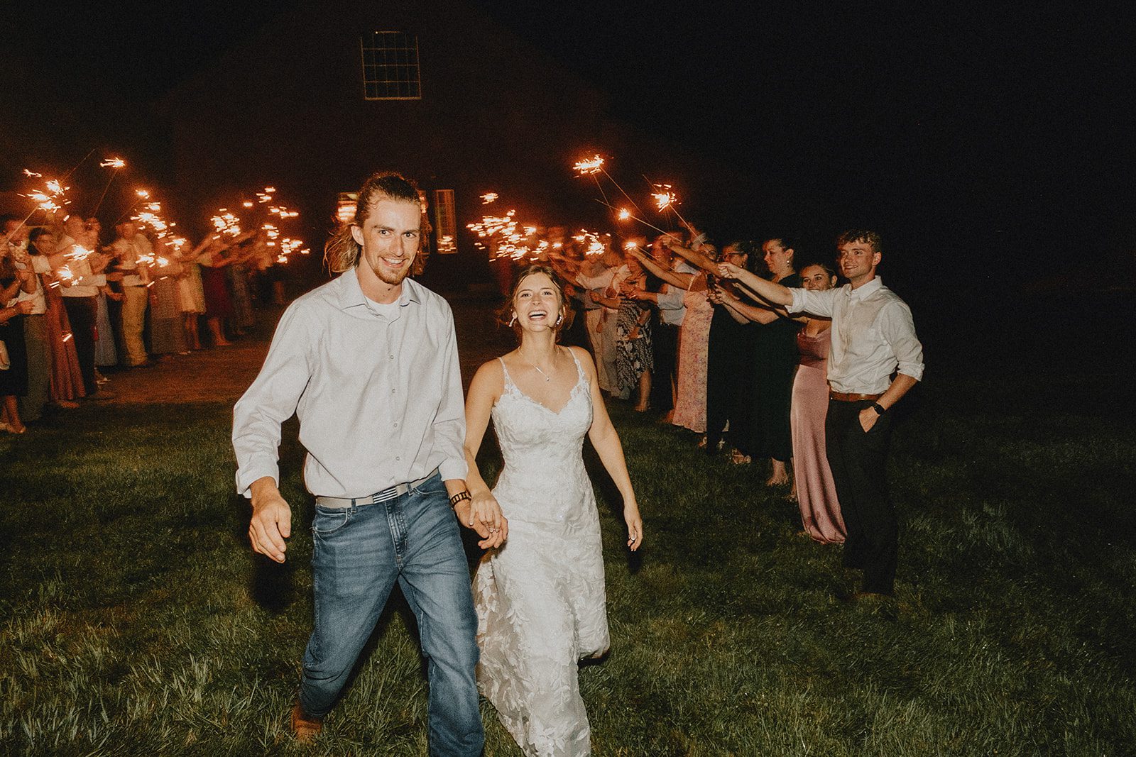 Couple running through the sparkler line Couple running through the sparkler line