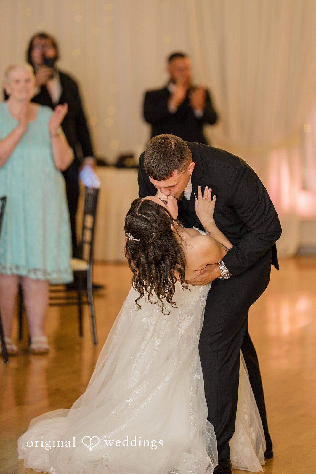 Emily + Angelo Groom dipping the bride during an enthusiastic dance at the wedding reception.