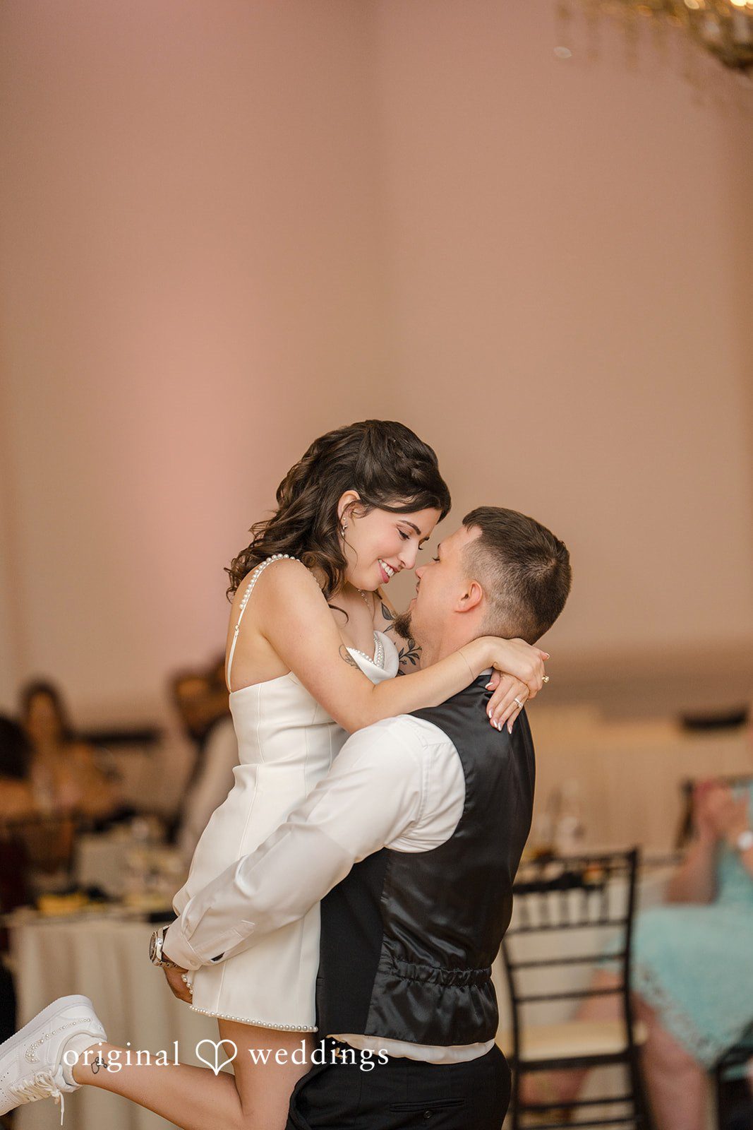 Emily + Angelo Bride and groom sharing a playful, energetic dance moment on the floor.