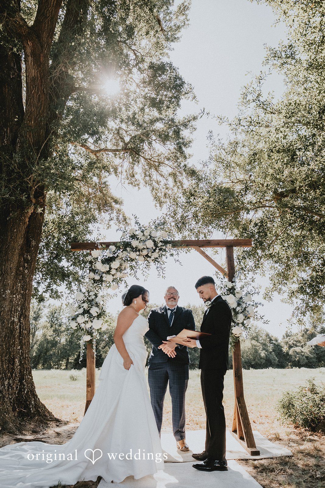Briana + Joshua Couple under the floral arch