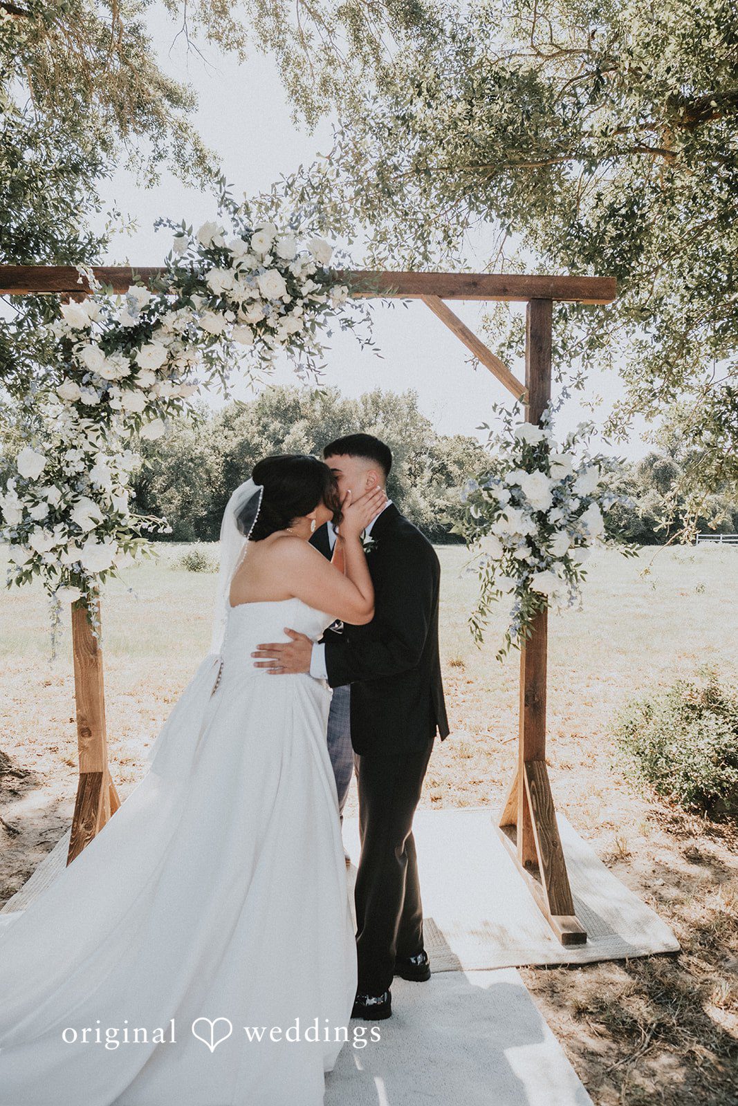 Briana + Joshua Couple kissing at the arch at Always Timeless Barn