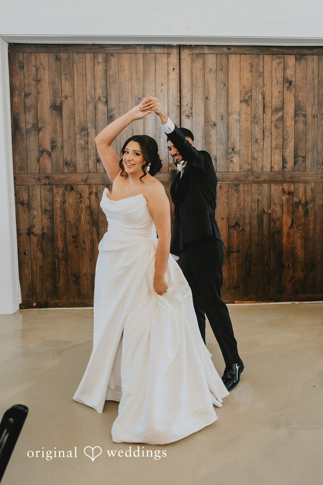Briana + Joshua Couple dancing by the barn doors
