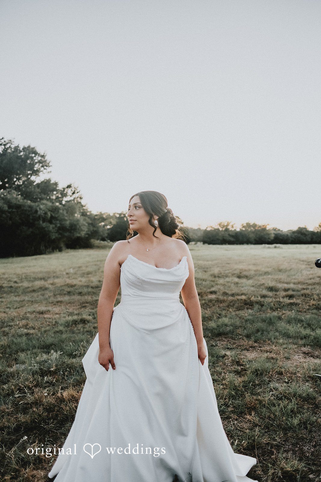 Briana + Joshua Bride walking in the field at Always Timeless Barn