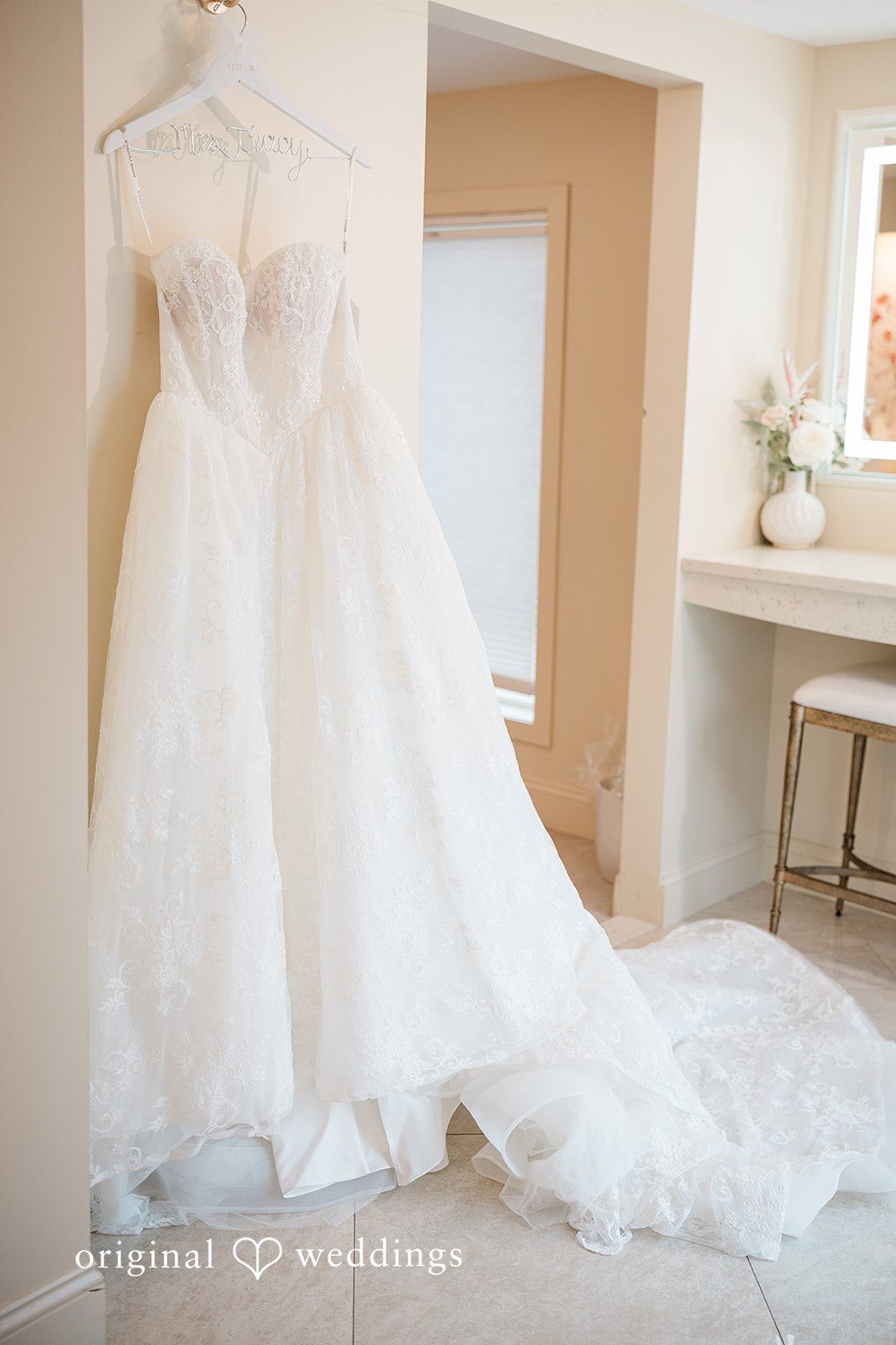 Jackie + Will Jackie's wedding dress hanging before the ceremony