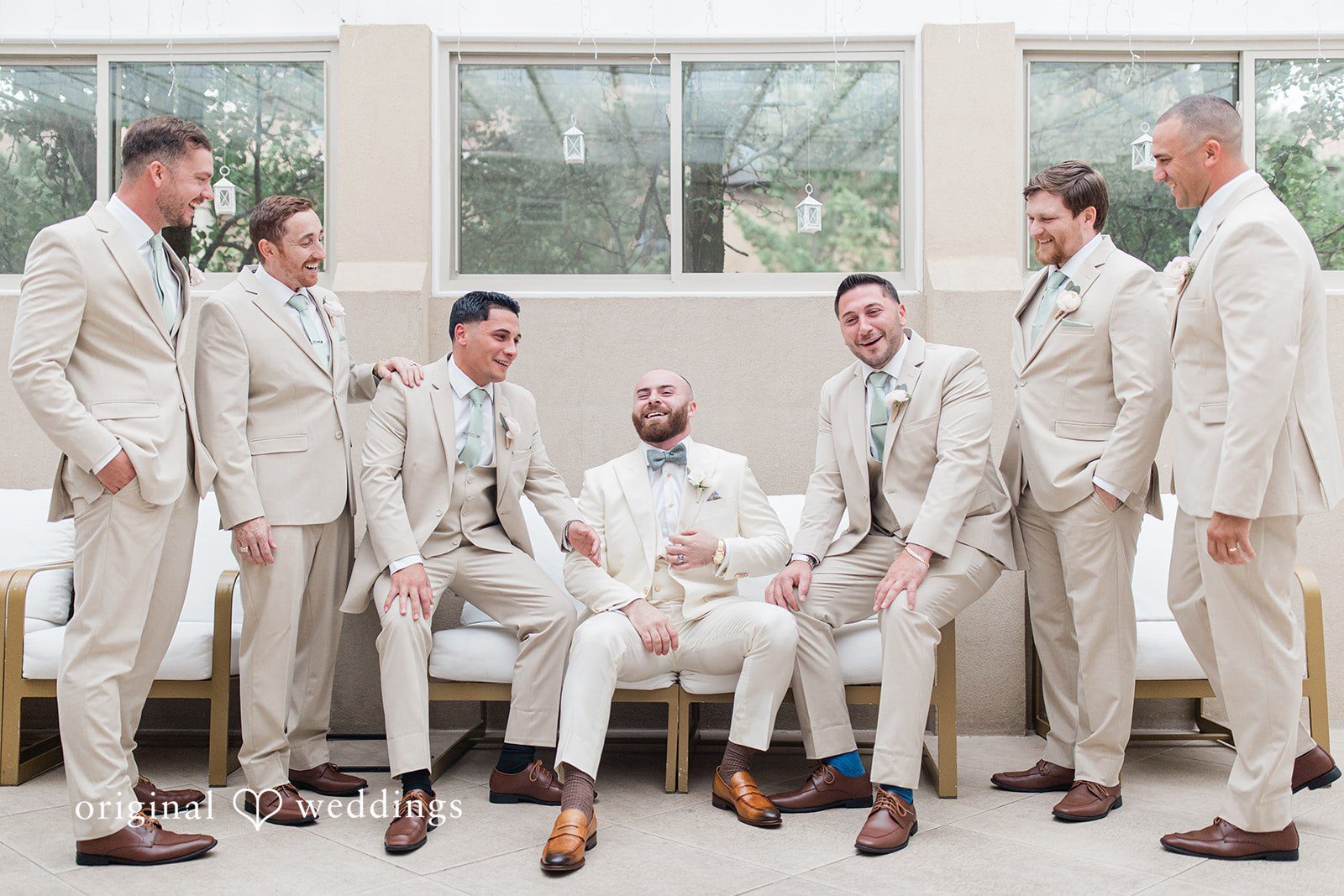 Jackie + Will Groom with his groomsmen in matching suits