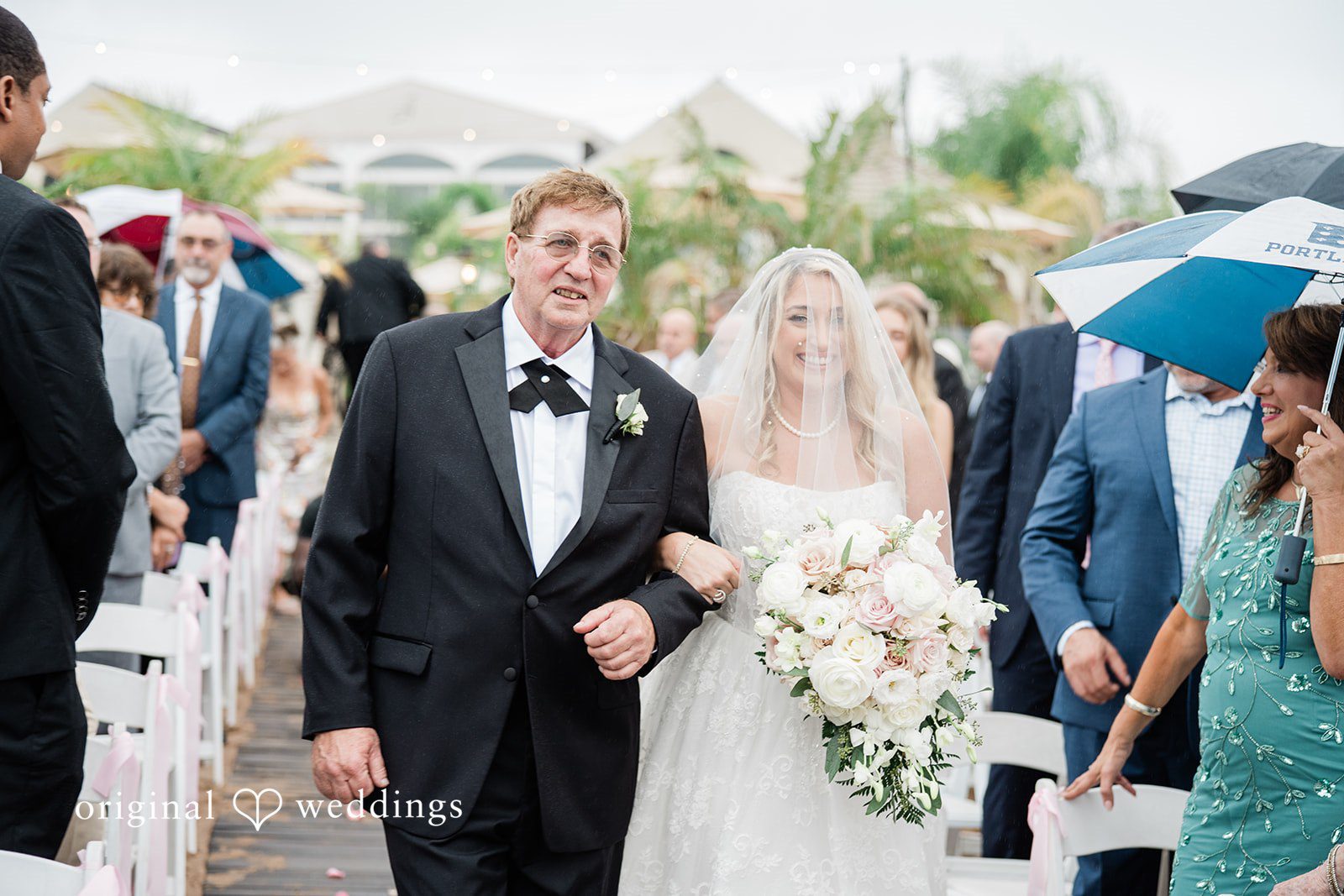 Jackie + Will Newlyweds walking back up the aisle with guests