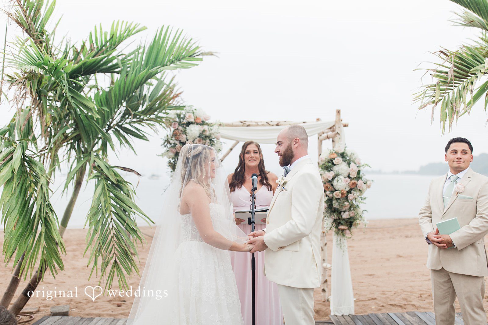 Jackie + Will Beachside ceremony under the floral arch at Anthony's Ocean View