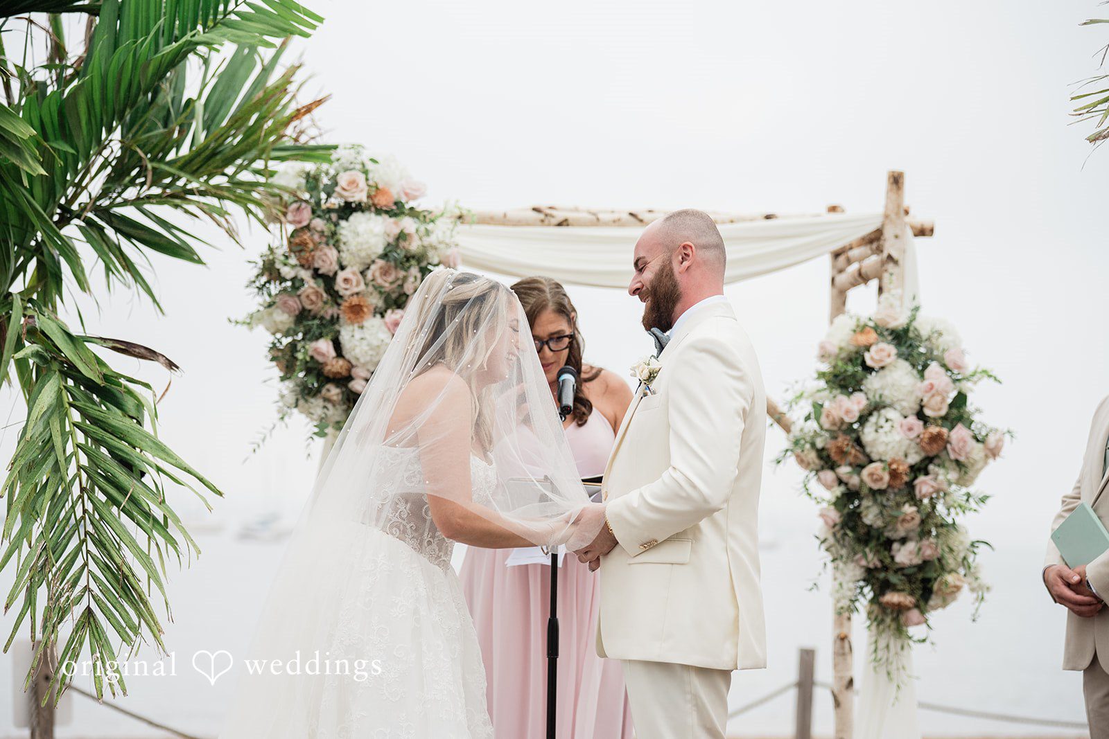 Jackie + Will Jackie and Will exchanging vows under the arch