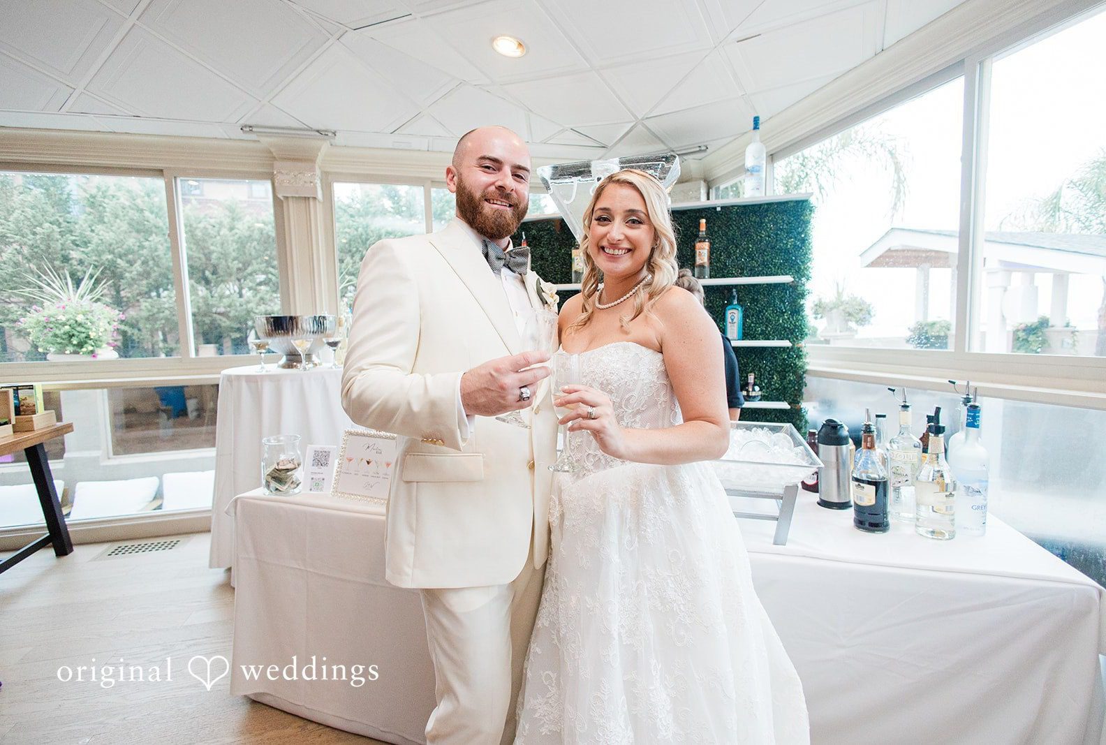 Jackie and Will by the bright windows, captured by New York wedding photographers from Original Weddings at Anthony's Ocean View