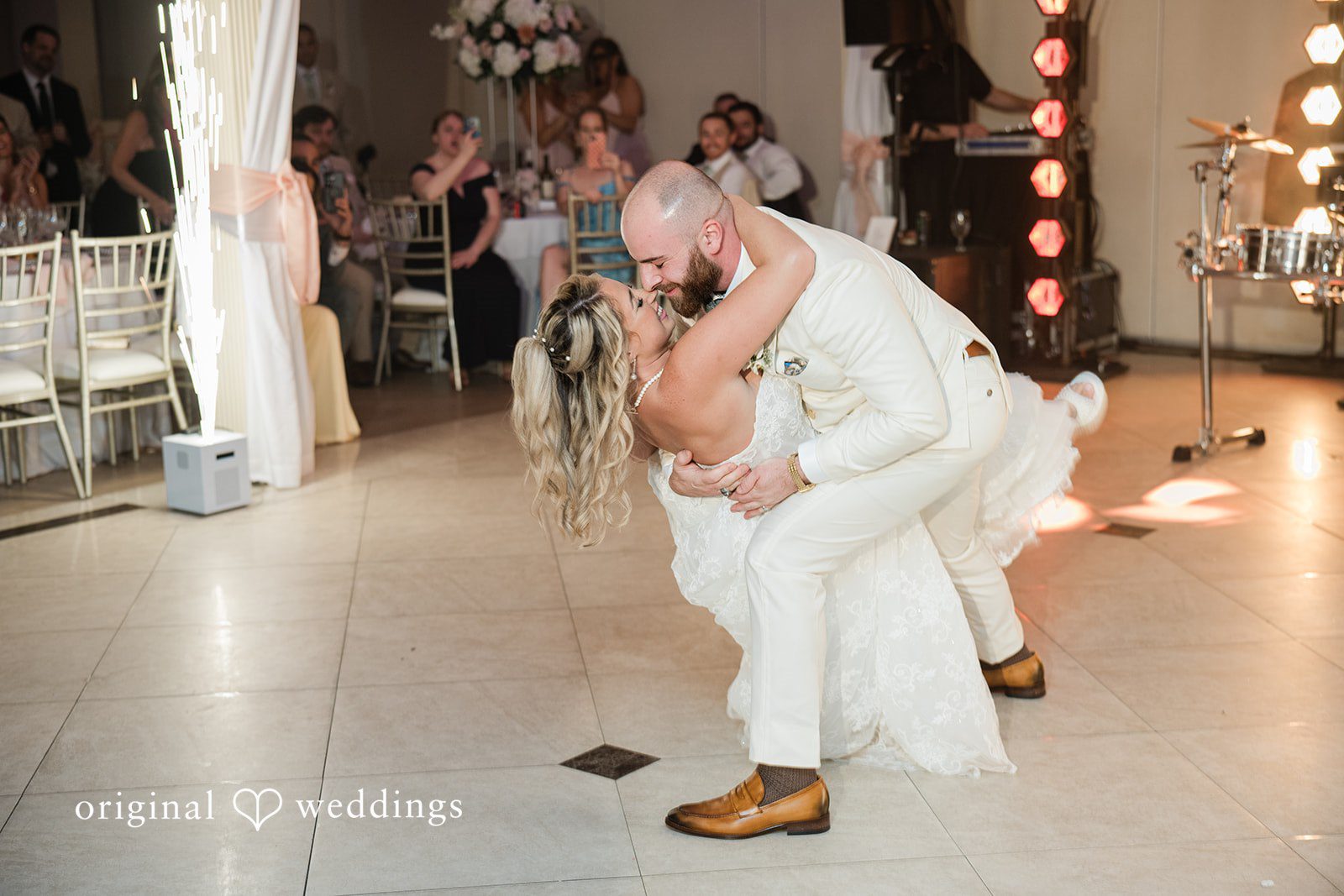 Jackie + Will Groom kneeling during a reception dance