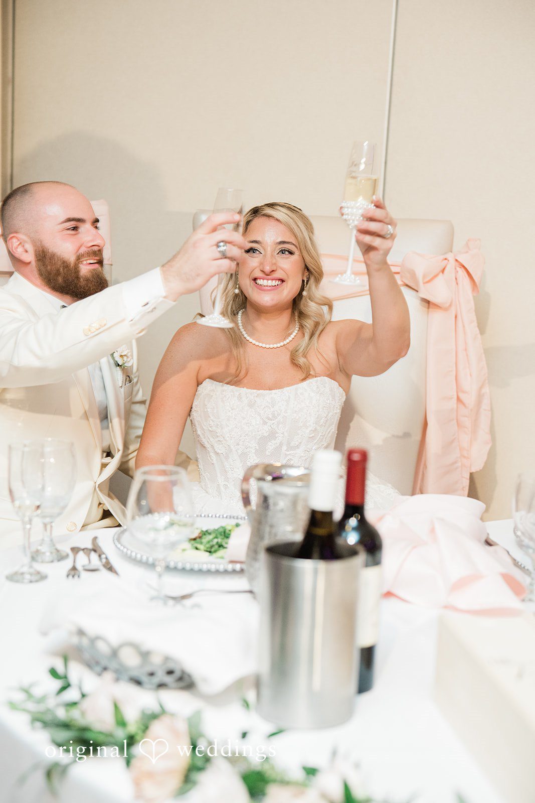 Jackie + Will Couple toasting at the sweetheart table