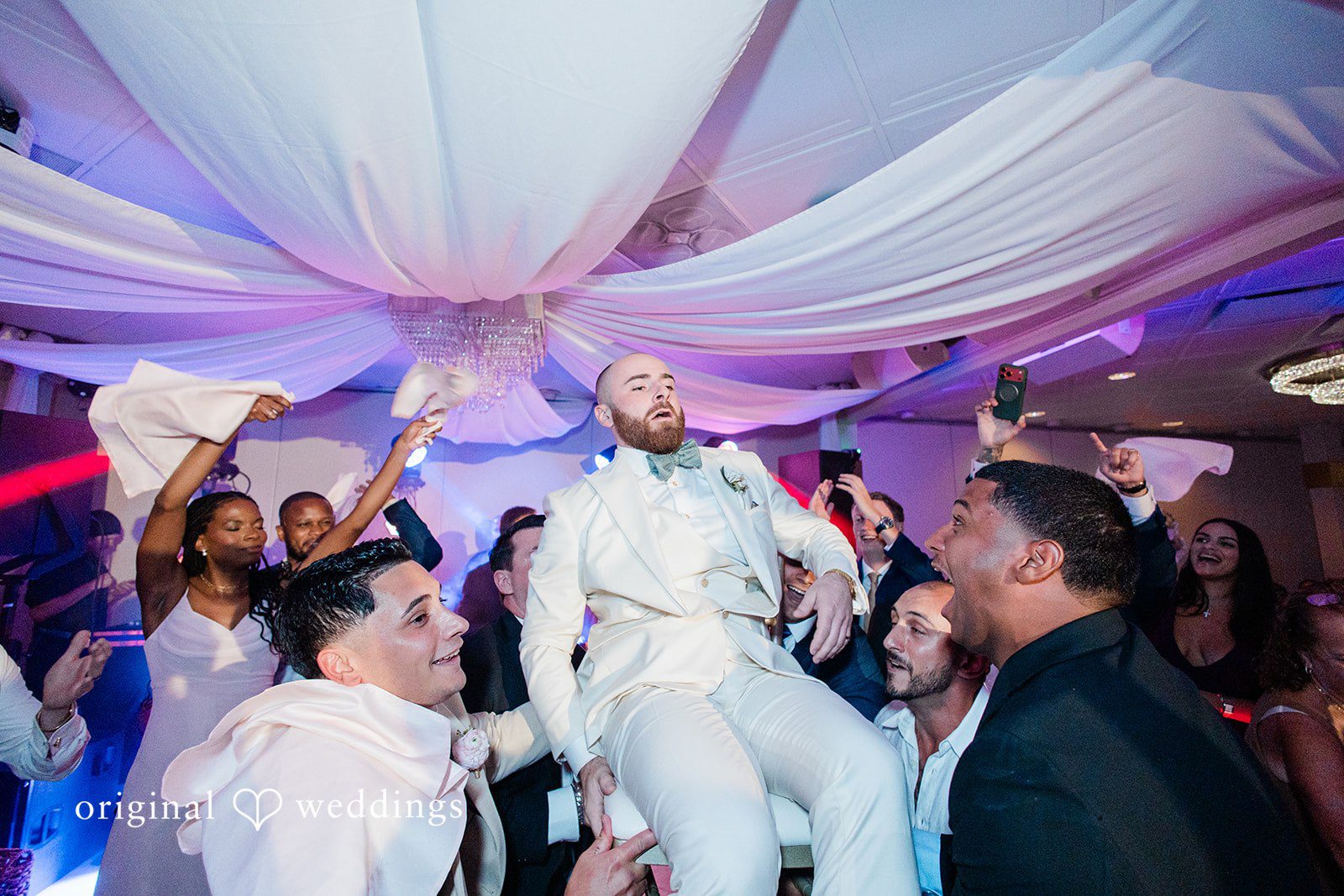 Jackie + Will Couple lifted in chairs during the reception