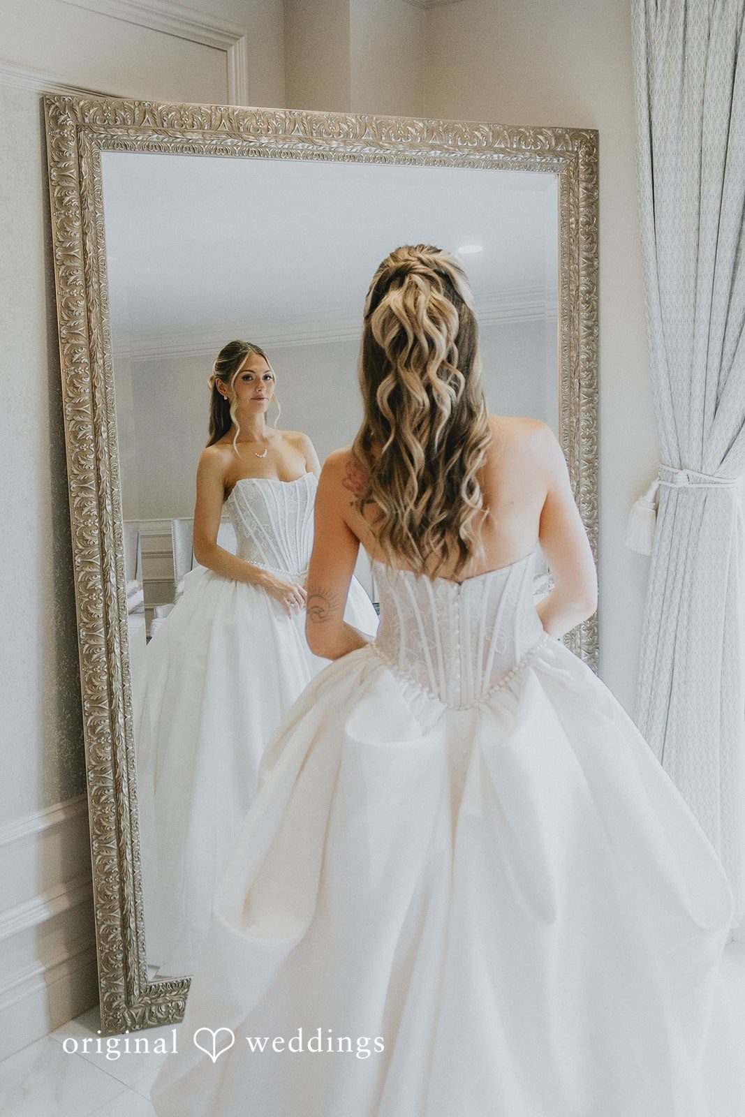 Emily + Max Emily checking her gown in the mirror