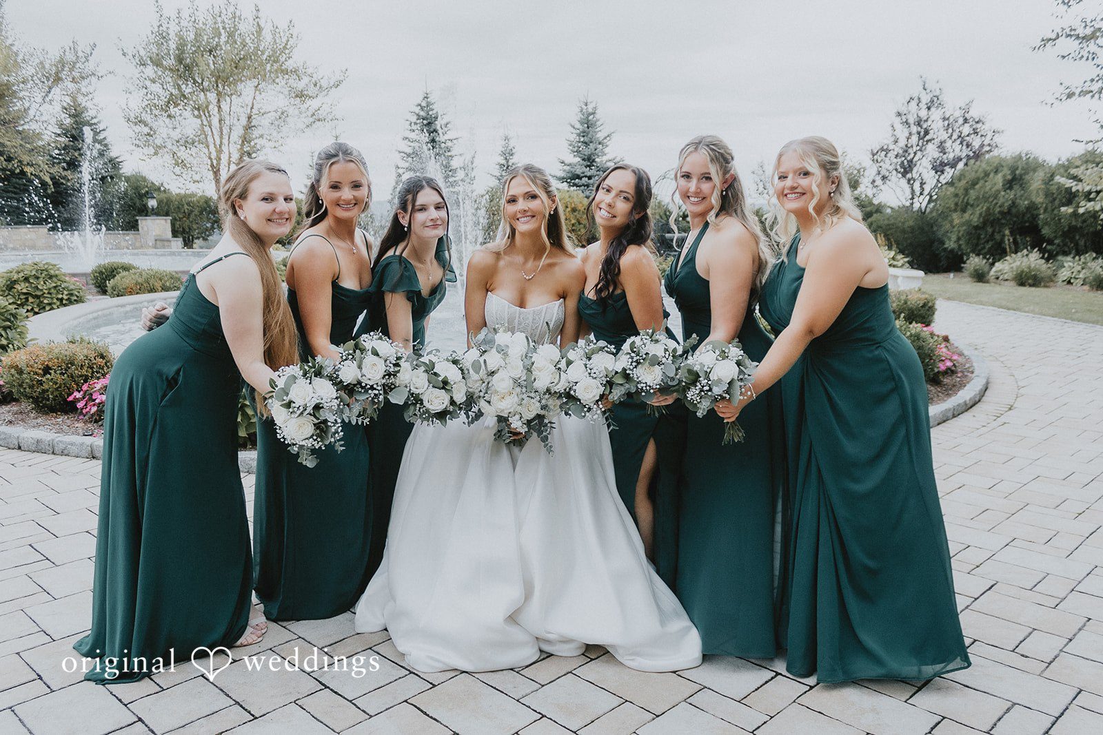 Emily + Max Emily with her bridesmaids in emerald dresses