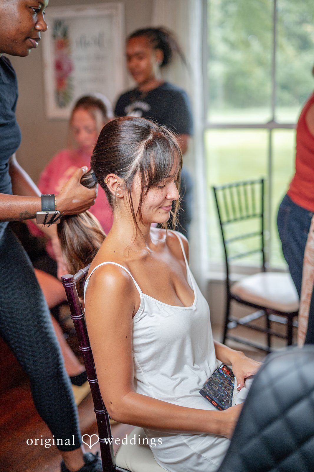 Bride putting on her earrings