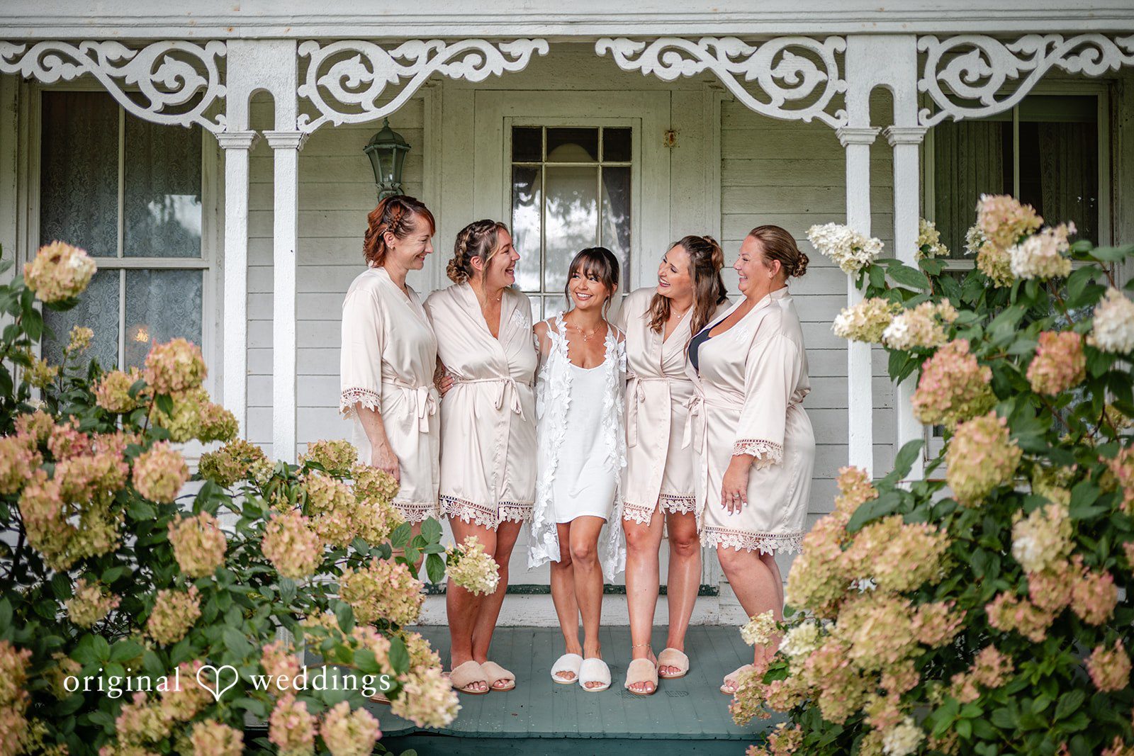 Bridesmaids posing on the farmhouse porch