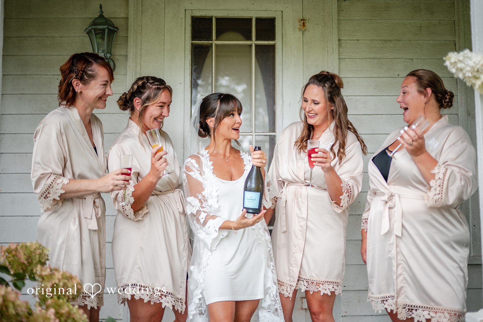Bride and bridesmaids celebrating in robes