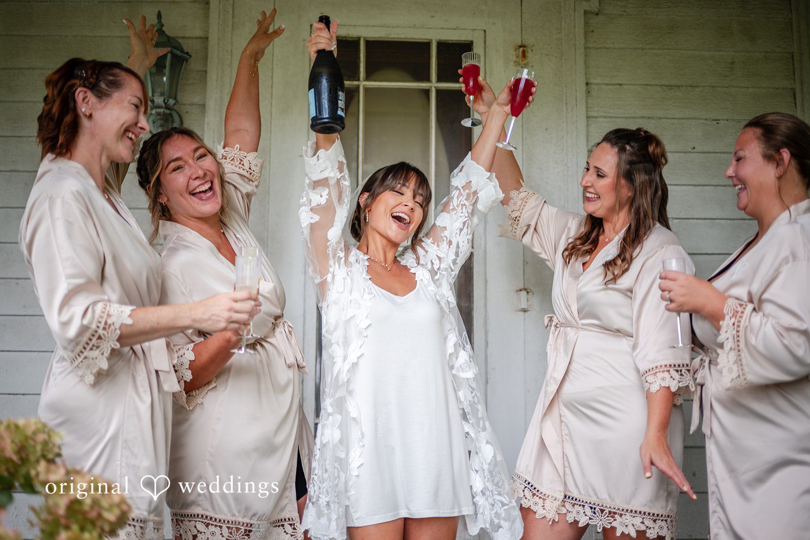 Bride celebrating with her bridesmaids in robes