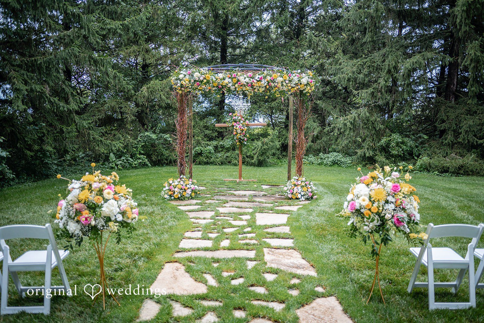 Ceremony arch and stone path set up on the lawn at Ashley Farm
