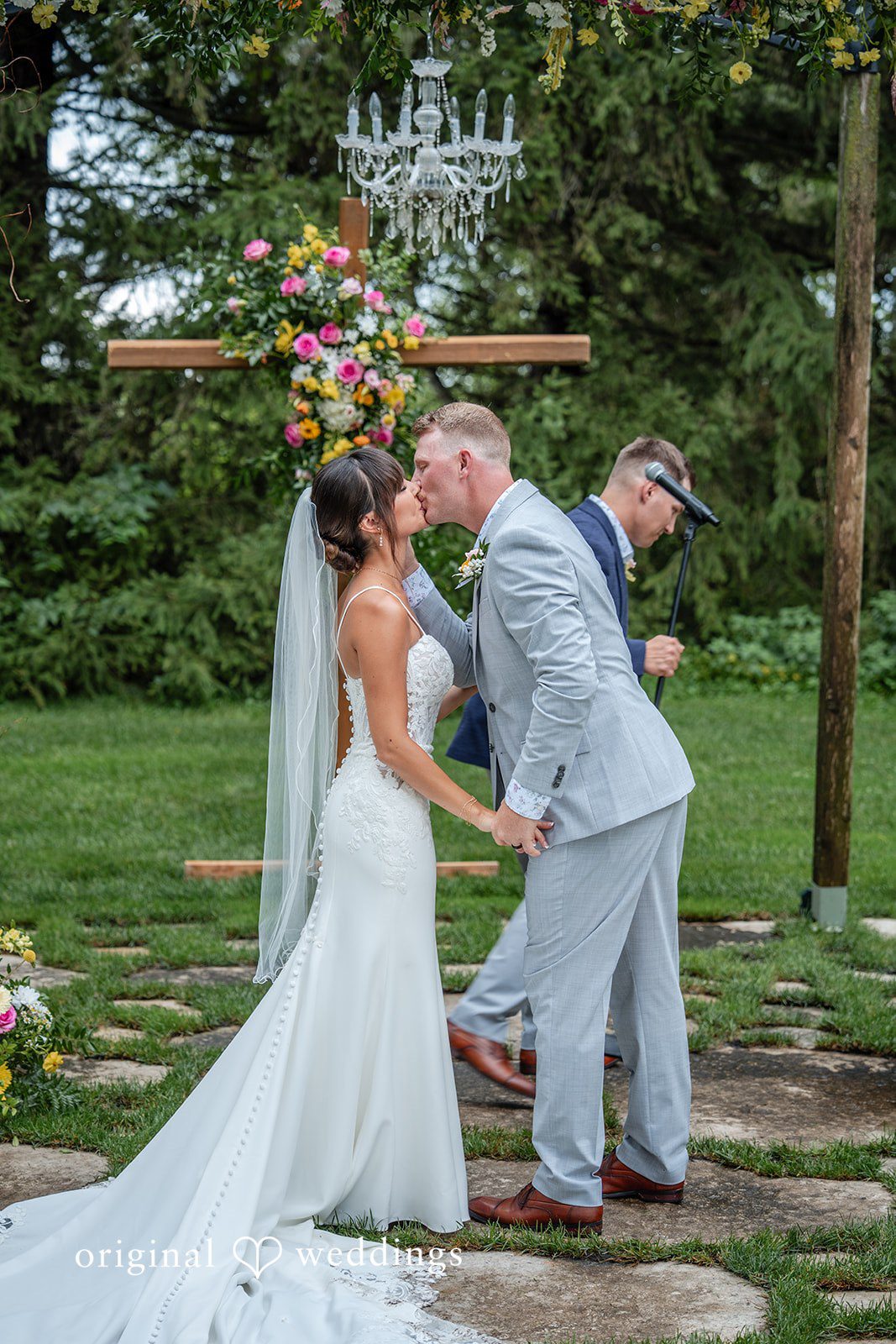 First kiss under the ceremony arch