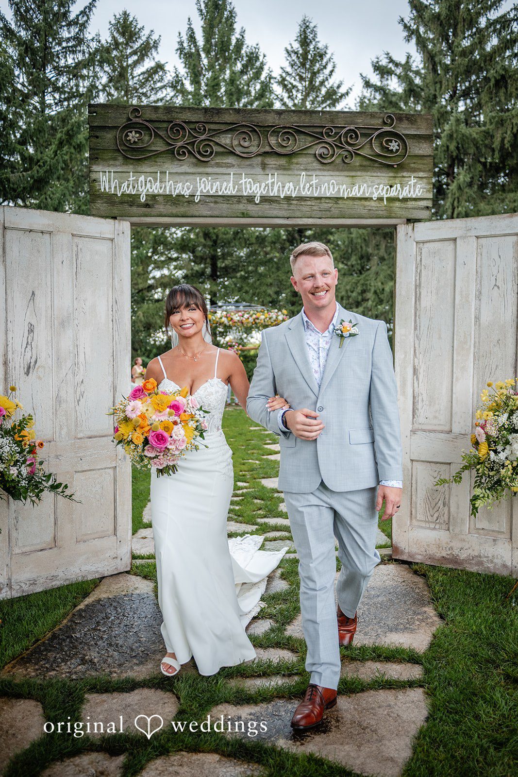 Couple standing in a garden gateway at Ashley Farm