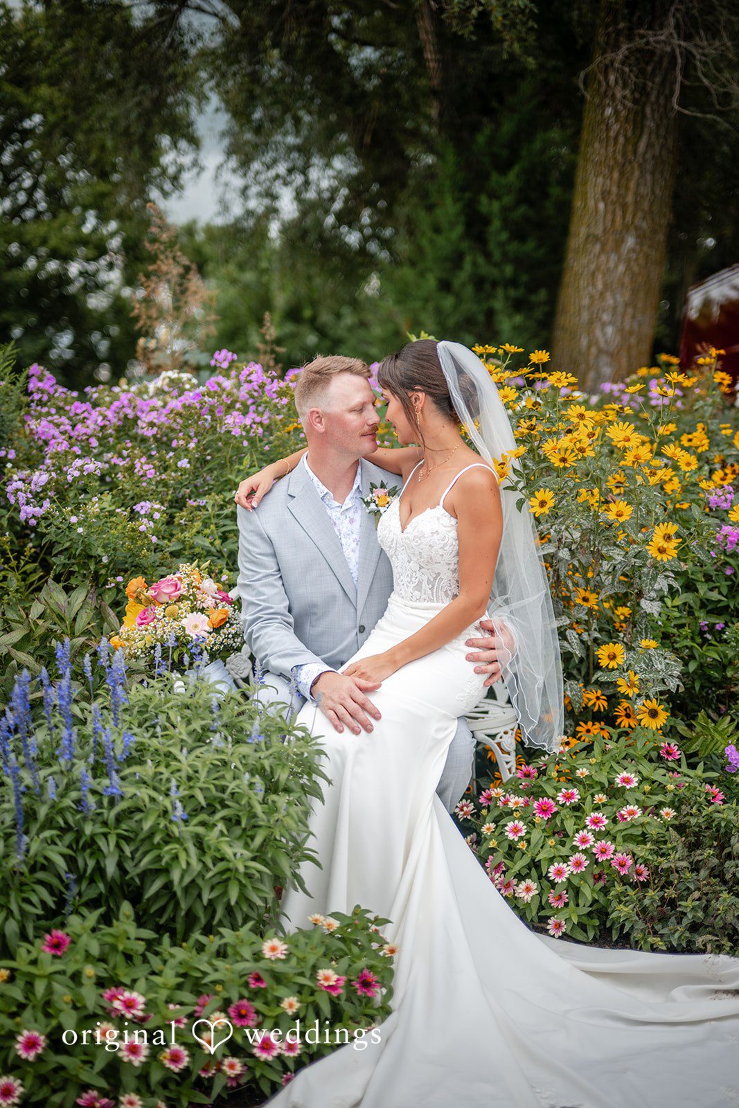Couple surrounded by colorful flowers