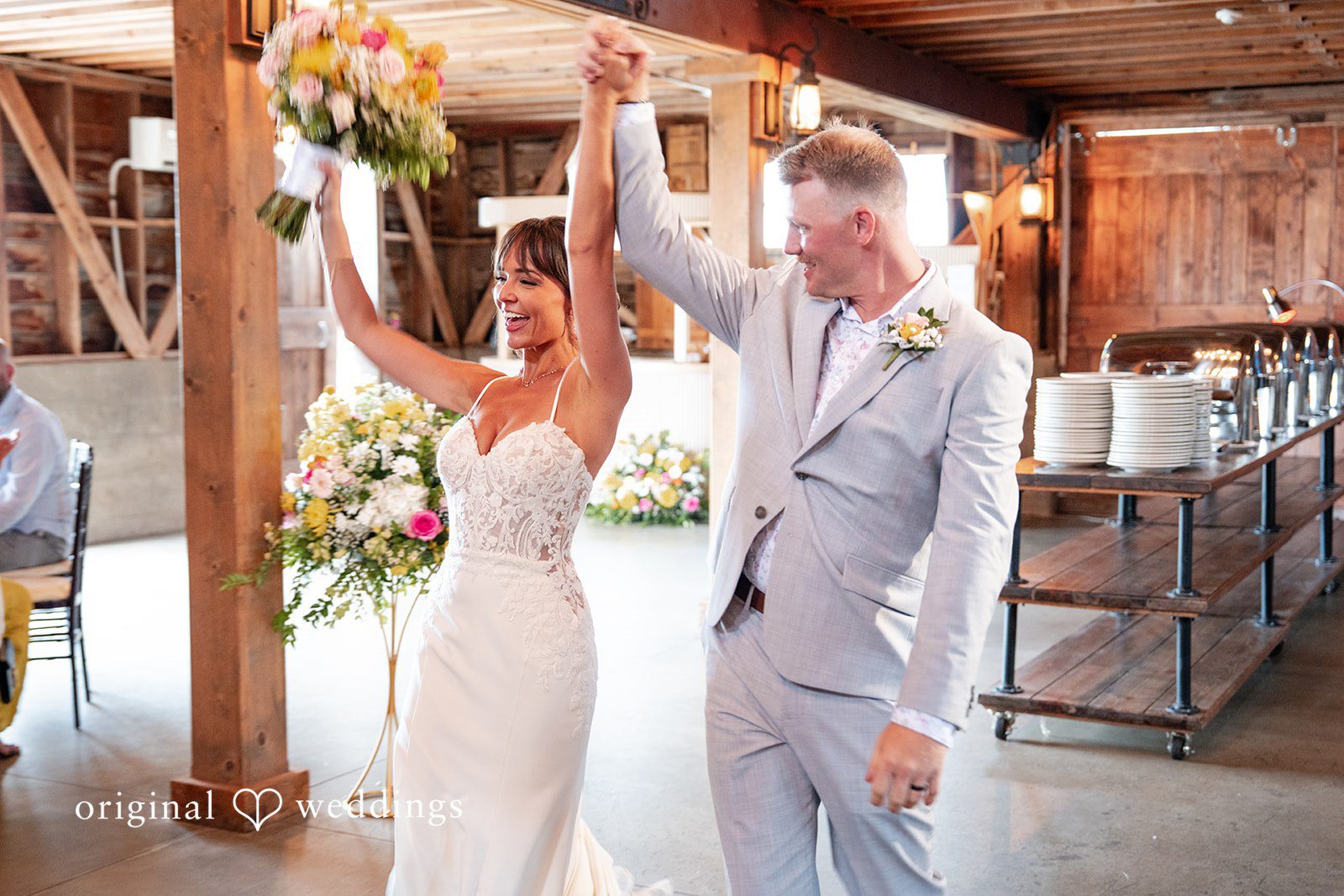 Couple cheering as they enter the reception
